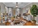 Inviting living room with an ottoman, hardwood floors and a large house plant at 121 Rising Star Rd, Fayetteville, GA 30215