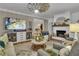 Spacious living room with hardwood floors, a windmill ceiling fan, and a cozy fireplace at 121 Rising Star Rd, Fayetteville, GA 30215