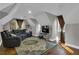 Spacious bonus room with leather seating and a flat-screen TV at 121 Rising Star Rd, Fayetteville, GA 30215
