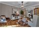 Elegant living room with a cowhide rug, wooden chandelier and direct access to the fireplace at 121 Rising Star Rd, Fayetteville, GA 30215