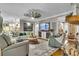 Open concept living room with elegant furnishings, flowing into an adjacent kitchen and seating area at 121 Rising Star Rd, Fayetteville, GA 30215