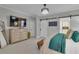 This primary bedroom features a decorative dresser, chandelier, television and sliding barn door bathroom access at 121 Rising Star Rd, Fayetteville, GA 30215