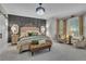 Elegant main bedroom featuring a decorative accent wall, chandelier, and sitting area at 121 Rising Star Rd, Fayetteville, GA 30215