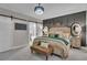 Elegantly styled bedroom showcases barn door access to the main bathroom, paneled accent wall, and beautiful chandelier at 121 Rising Star Rd, Fayetteville, GA 30215