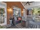 Inviting covered porch with stylish outdoor seating, area rug, and a view of the manicured backyard at 121 Rising Star Rd, Fayetteville, GA 30215