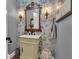 Charming powder room featuring vintage wallpaper, an ornate mirror, and sconce lighting at 121 Rising Star Rd, Fayetteville, GA 30215