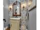 Stylish powder room featuring unique wallpaper, a vanity, and ornate mirror at 121 Rising Star Rd, Fayetteville, GA 30215