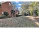 Spacious side yard showcasing a beautiful brick home and mature landscaping at 121 Rising Star Rd, Fayetteville, GA 30215
