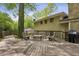 Wooden deck with outdoor seating and a grill, overlooking a serene backyard with mature trees at 205 Glencourtney Dr, Sandy Springs, GA 30328