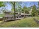 Spacious backyard featuring a large deck, patio areas, and lush greenery, perfect for outdoor living at 205 Glencourtney Dr, Sandy Springs, GA 30328