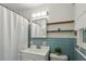 Bathroom with blue tile, a white shower curtain, a vanity with a sink, and an updated light fixture at 205 Glencourtney Dr, Sandy Springs, GA 30328