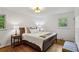 Bedroom showcasing hardwood floors, two windows, and a comfortably appointed bed with side tables and lamps at 205 Glencourtney Dr, Sandy Springs, GA 30328