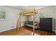 Bedroom featuring hardwood floors, a loft bed with a futon underneath, and a dark wood dresser at 205 Glencourtney Dr, Sandy Springs, GA 30328