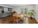 Bright dining area featuring wood floors, a round table, and access to the outdoors through glass doors at 205 Glencourtney Dr, Sandy Springs, GA 30328