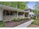 Inviting front porch with white decorative columns and manicured landscaping and walkway at 205 Glencourtney Dr, Sandy Springs, GA 30328