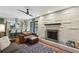 Cozy living room with fireplace and access to open-concept kitchen at 205 Glencourtney Dr, Sandy Springs, GA 30328