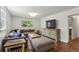 Living room with hardwood floors, a window, a large TV, and a comfortable sectional sofa at 205 Glencourtney Dr, Sandy Springs, GA 30328