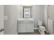 Bathroom with a vanity, mirror, and toilet next to a tile shower at 269 Devin Ne Pl, Atlanta, GA 30305