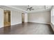 Spacious bedroom with tray ceiling and hardwood floors showcasing dual doors, including one to the ensuite bathroom at 269 Devin Ne Pl, Atlanta, GA 30305