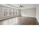 Primary bedroom with tray ceiling, large windows, and hardwood floors at 269 Devin Ne Pl, Atlanta, GA 30305