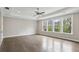 A spacious bedroom features hardwood floors, a tray ceiling, and large windows offering ample natural light at 269 Devin Ne Pl, Atlanta, GA 30305