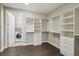 Custom walk-in closet with built-in shelving and drawers, as well as an adjacent laundry room at 269 Devin Ne Pl, Atlanta, GA 30305