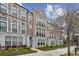 Brick townhome featuring black trim windows and manicured landscaping at 269 Devin Ne Pl, Atlanta, GA 30305
