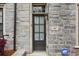 Exterior front door featuring stone detailing with an ADT security sign at 269 Devin Ne Pl, Atlanta, GA 30305