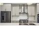 Gourmet kitchen with stainless steel appliances, range hood, and marble backsplash at 269 Devin Ne Pl, Atlanta, GA 30305