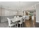 Open concept dining area with modern light fixture and hardwood floors that flows into the kitchen at 269 Devin Ne Pl, Atlanta, GA 30305