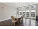 Bright dining room featuring dark hardwood floors, a modern light fixture, and large windows at 269 Devin Ne Pl, Atlanta, GA 30305