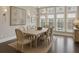 Bright dining room featuring a modern light fixture, dark hardwood floors, and large windows providing abundant natural light at 269 Devin Ne Pl, Atlanta, GA 30305