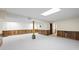 Open basement space with neutral carpet, paneled walls and bright lighting at 5269 Wyntercreek Dr, Atlanta, GA 30338