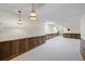 Finished basement featuring wood paneling, neutral carpet, and hanging pendant lamps at 5269 Wyntercreek Dr, Atlanta, GA 30338