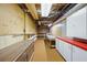 Unfinished basement space featuring pegboard wall and cabinets for storage at 5269 Wyntercreek Dr, Atlanta, GA 30338