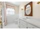 Bathroom with white tiled floors and a vanity with a white marble countertop, a window, and shower at 5269 Wyntercreek Dr, Atlanta, GA 30338