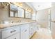 Bathroom with dual sinks, granite countertops, white cabinets, and gold fixtures offers a luxurious feel at 5269 Wyntercreek Dr, Atlanta, GA 30338