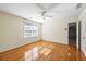 Light-filled bedroom boasts gleaming hardwood floors, ceiling fan, and a view of the hallway through the doorway at 5269 Wyntercreek Dr, Atlanta, GA 30338
