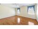 Inviting bedroom features gleaming wood floors, two windows with blue curtains, and a ceiling fan at 5269 Wyntercreek Dr, Atlanta, GA 30338