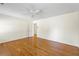 Light-filled bedroom features wood floors, ceiling fan, and a view through the doorway to the hallway at 5269 Wyntercreek Dr, Atlanta, GA 30338