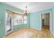 Bright dining area with wood floors, many windows with light coming through, and aqua painted walls at 5269 Wyntercreek Dr, Atlanta, GA 30338