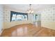 Classic dining room featuring hardwood floors, chandelier, and large window at 5269 Wyntercreek Dr, Atlanta, GA 30338