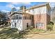 Back exterior view showcasing a sunroom, brick facade, and a spacious yard at 5269 Wyntercreek Dr, Atlanta, GA 30338