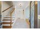 Inviting foyer with tile floors, wooden staircase, and a decorative front door at 5269 Wyntercreek Dr, Atlanta, GA 30338
