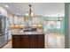 Bright kitchen with an island gas cooktop, stainless steel appliances, light countertops and white cabinets at 5269 Wyntercreek Dr, Atlanta, GA 30338