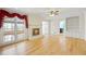 Living room with wood floors, fireplace, ceiling fan, built in bookcase and cabinets, and bright windows at 5269 Wyntercreek Dr, Atlanta, GA 30338