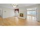 Bright Living room with wood floors, fireplace, ceiling fan, and entrance to sunroom at 5269 Wyntercreek Dr, Atlanta, GA 30338