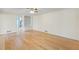 Open Living room with wood floors, built in bookcase and cabinets, and view to kitchen at 5269 Wyntercreek Dr, Atlanta, GA 30338