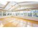 Bright sunroom features skylights, and many windows that fill the space with natural light and hardwood flooring at 5269 Wyntercreek Dr, Atlanta, GA 30338