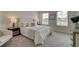 Cozy bedroom bathed in natural light, featuring plush carpeting and a serene ambiance perfect for restful nights at 1079 Georgian Point Dr, Lawrenceville, GA 30045